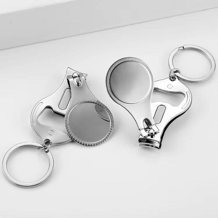 Two silver nail clipper keychains with round blank inserts and key rings, shown from front and back angles