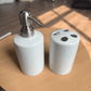 Blank white ceramic bathroom set: soap dispenser and four-hole toothbrush holder