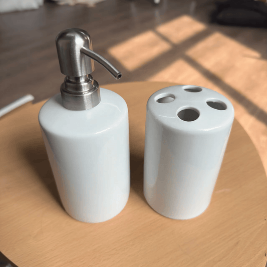 Blank white ceramic bathroom set: soap dispenser and four-hole toothbrush holder