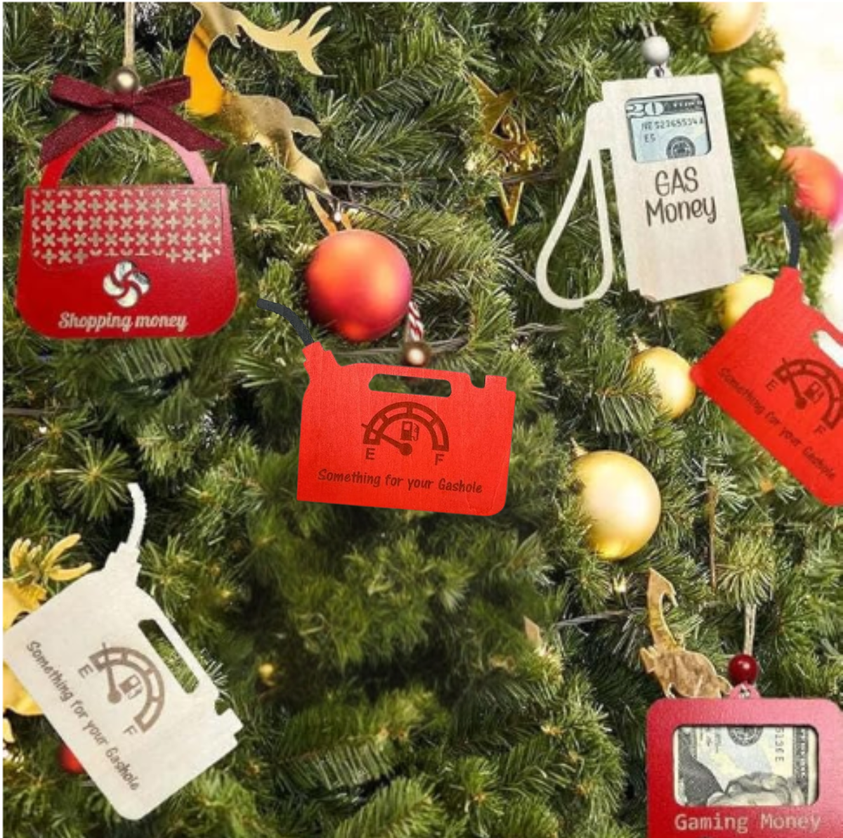 Wooden Christmas money holder ornaments on a tree including gas pump, gas can, purse, and photo frame designs