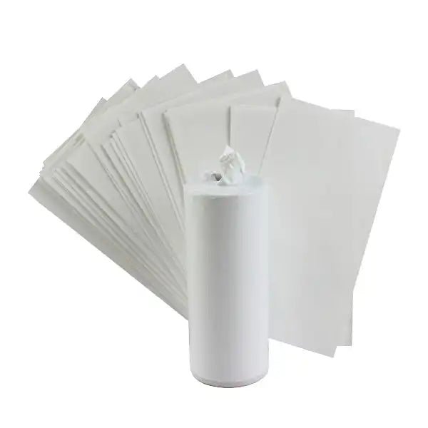 White sublimation shrink wrap sleeves for shot glasses, fanned out with a roll
