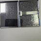 Open silver metal business card holder showing patterned metal interior and metal card-retaining bar