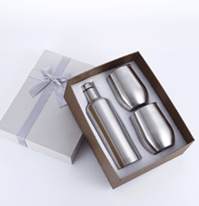 Stainless steel wine bottle and two stemless wine glasses in a ribbon-tied gift box