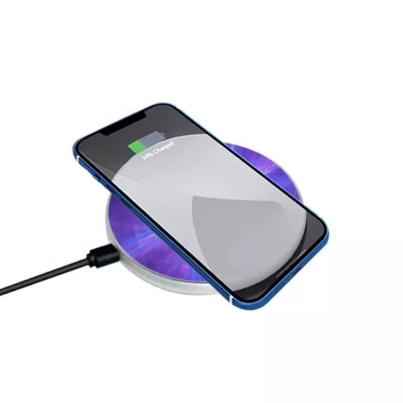 Round sublimation wireless phone charger with purple printed surface charging a smartphone