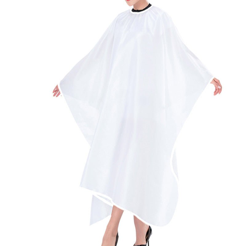 White sublimation salon hair stylist cape with black neckline, worn by a model