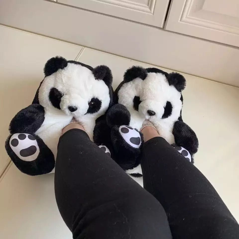 Panda teddy bear slippers worn on feet