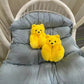 Yellow teddy bear slippers on a chair